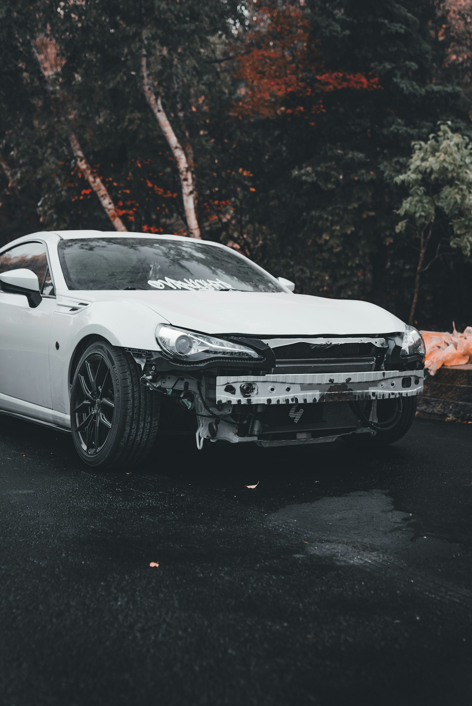 Car with front bumper removed during collision repair